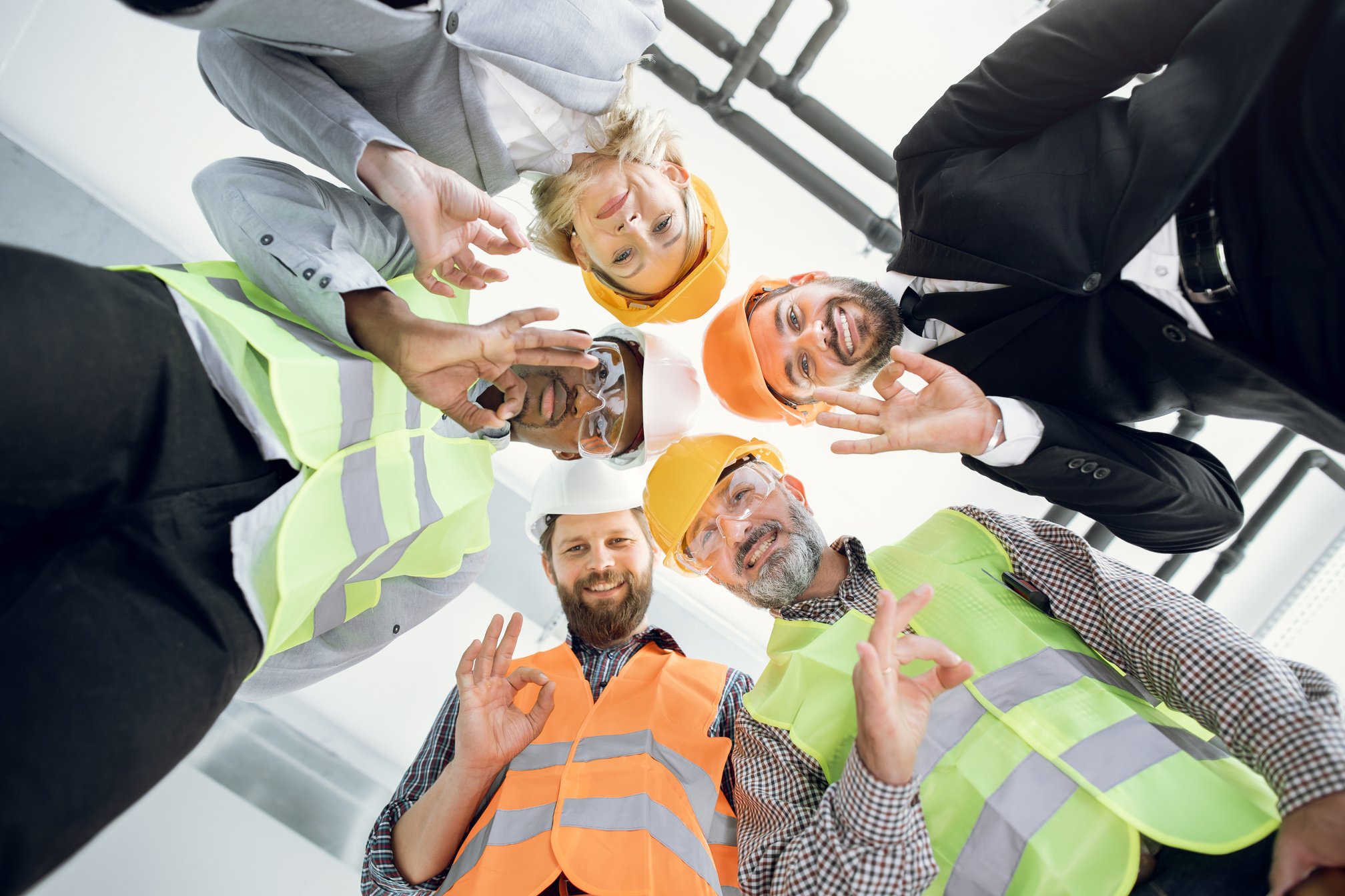 Multicultural construction team in protective helmet at work